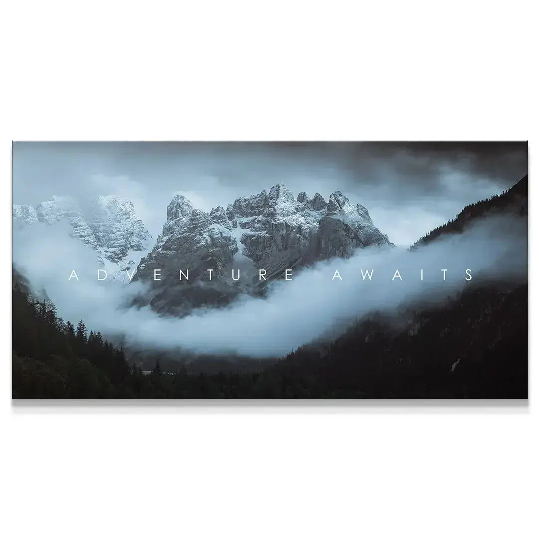 Dark, moody panoramic view of snow-capped mountains shrouded in fog, titled 'Chris Henry - Adventure Awaits'.