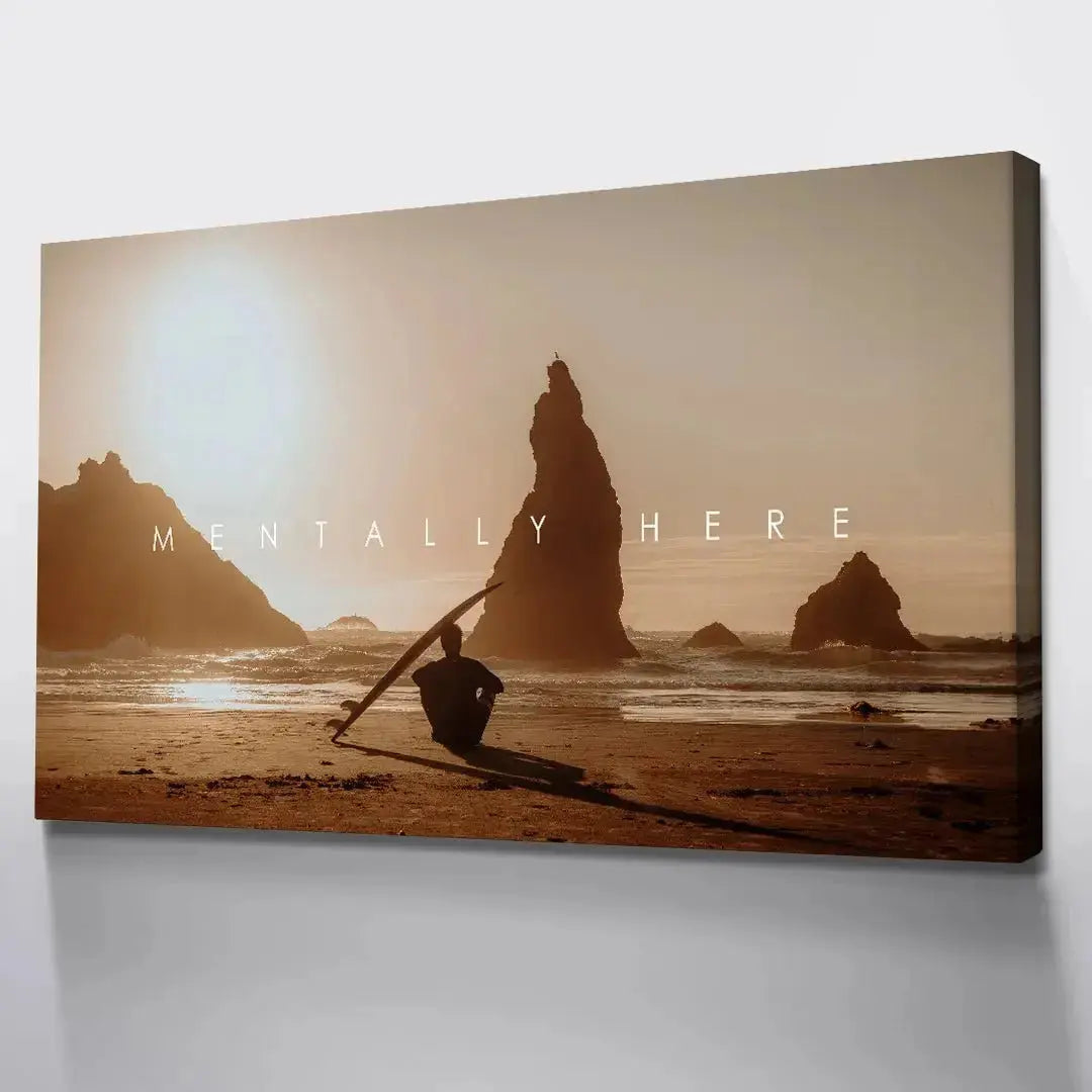 View emphasizing the long shadow cast by the seated figure and surfboard across the sandy foreground in 'Chris Henry - Mentally Here'.