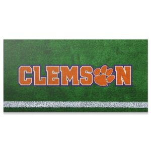 Clemson – Field Logo Wall Art Close-up shot of the vibrant orange and purple text of the Clemson - Field Logo on artificial turf.