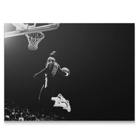 Dynamic black and white action shot of Clyde Drexler - #2 mid-dunk, soaring above the basket.
