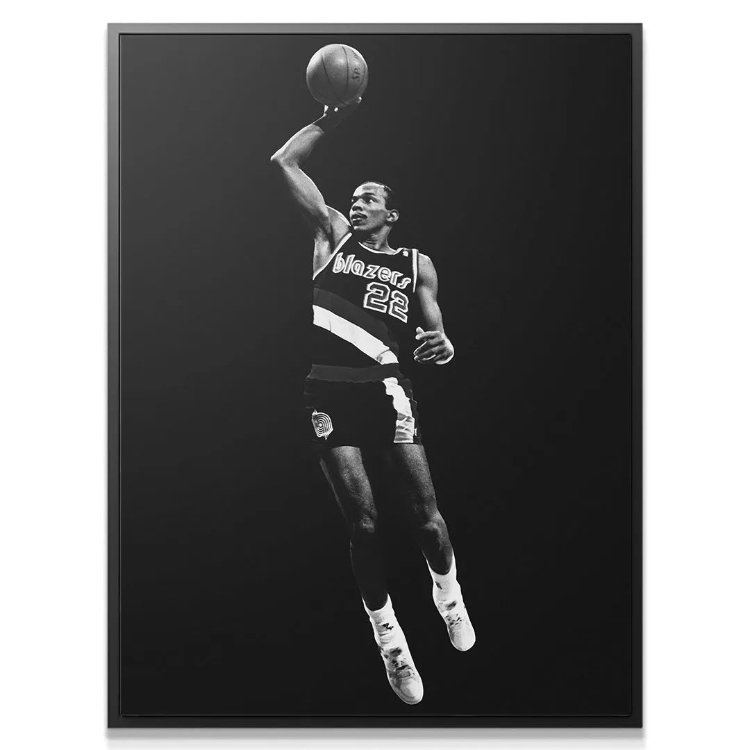 Close-up on the intensity of Clyde Drexler - #3's expression and ball handling technique
