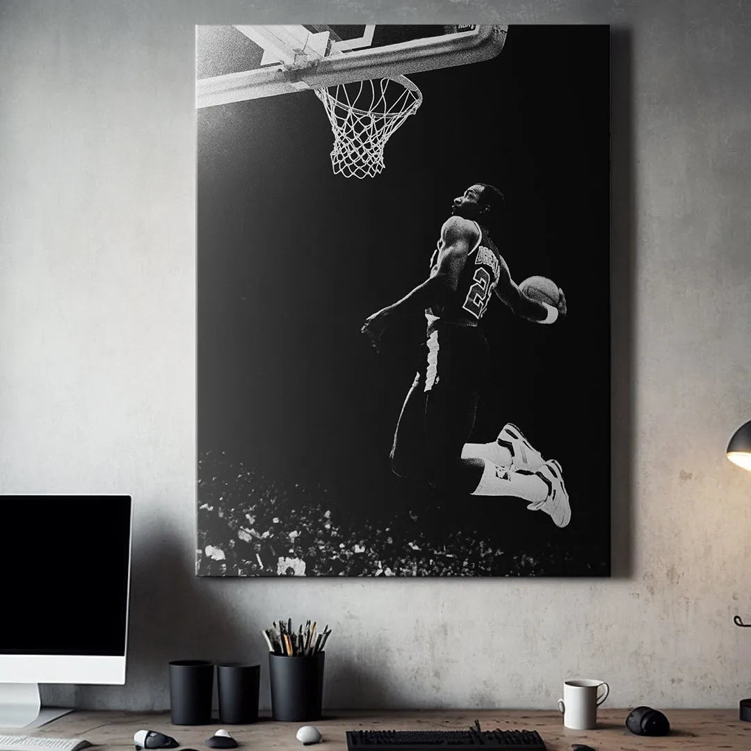 Action shot capturing the intense focus on the face of Clyde Drexler #4 as he prepares to score, highlighting athletic determination.