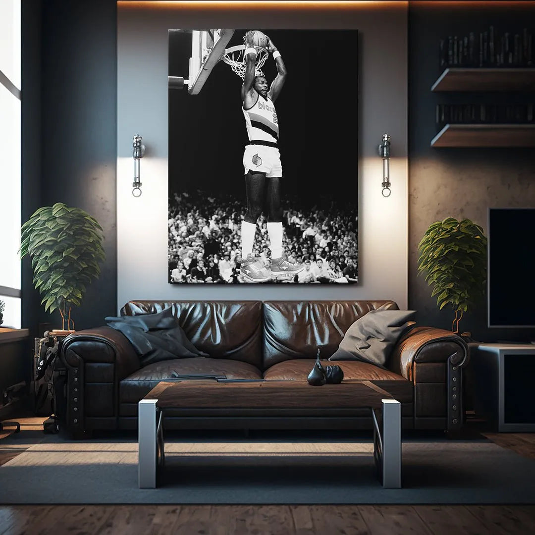 Low-angle perspective highlighting the dynamic lift of NBA superstar Clyde Drexler #5 reaching the hoop.