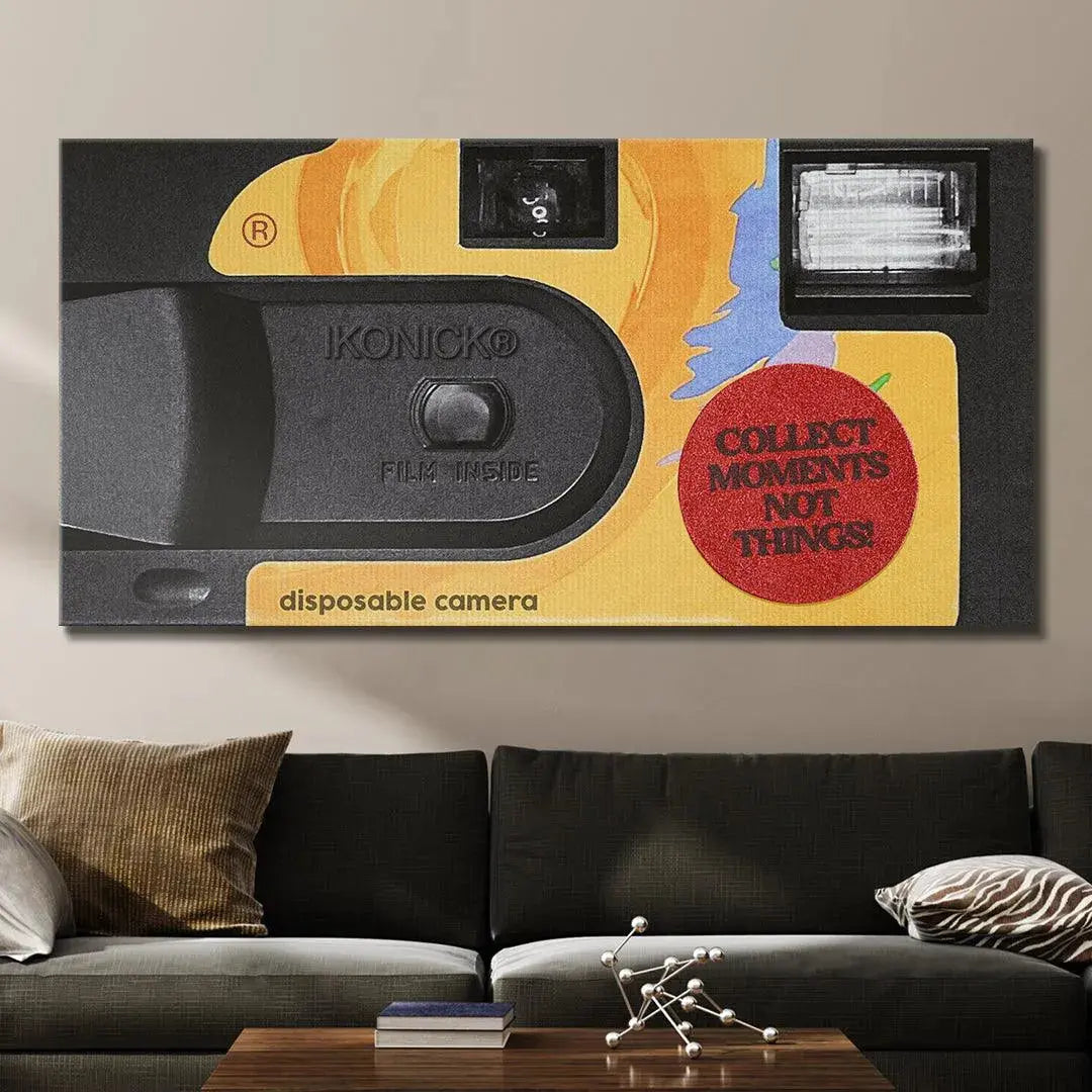 Texture shot showing the matte black plastic body and the yellow/orange paper packaging used to market the camera and Collect Moments.