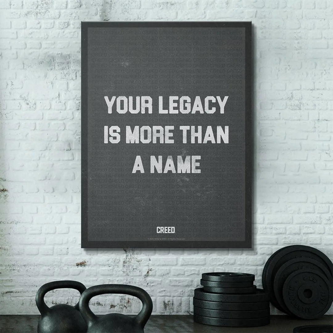 Lifestyle shot of the Creed - More Than A Name print hanging in a modern home gym setup.