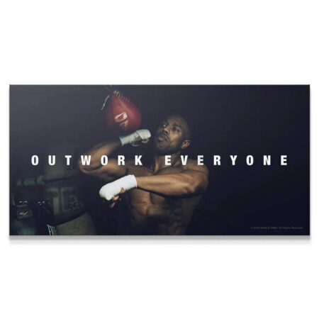 Adonis Creed close-up during intense training captured in the 'Creed - Outwork Everyone' poster art.