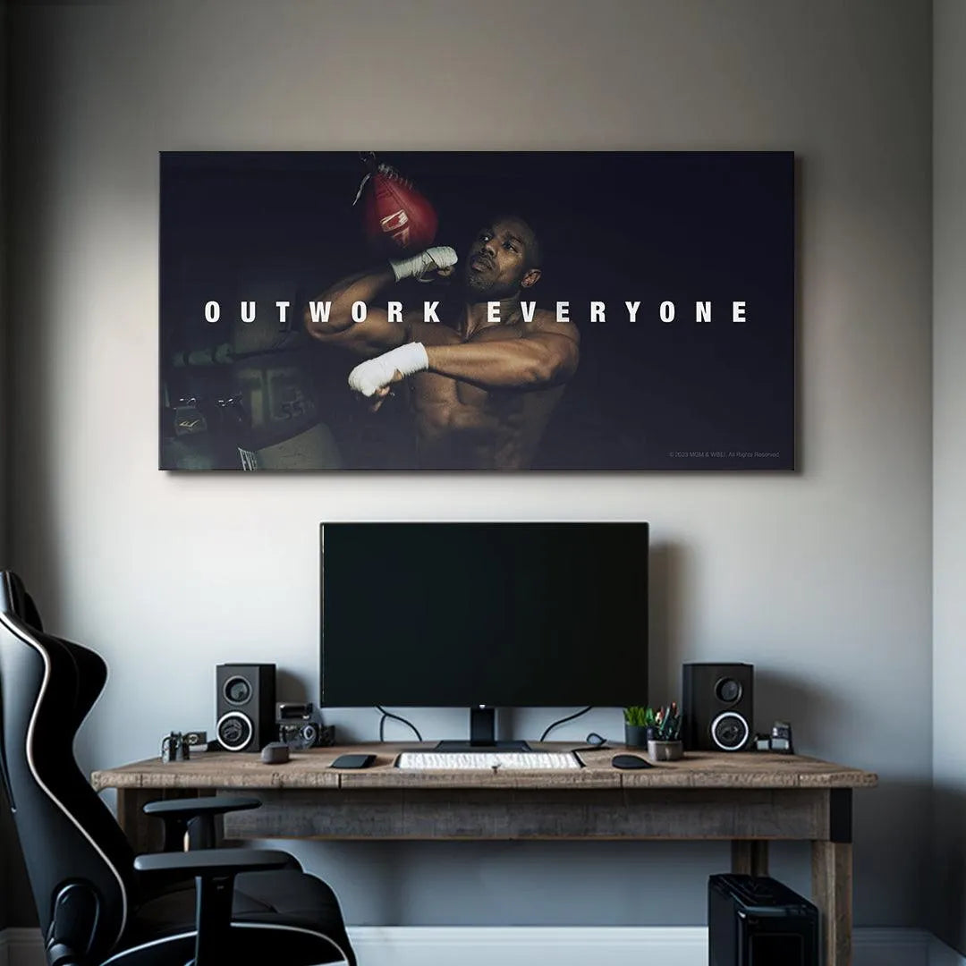 Inspirational gym decor featuring the 'Creed - Outwork Everyone' artwork enhancing the fitness motivation area.