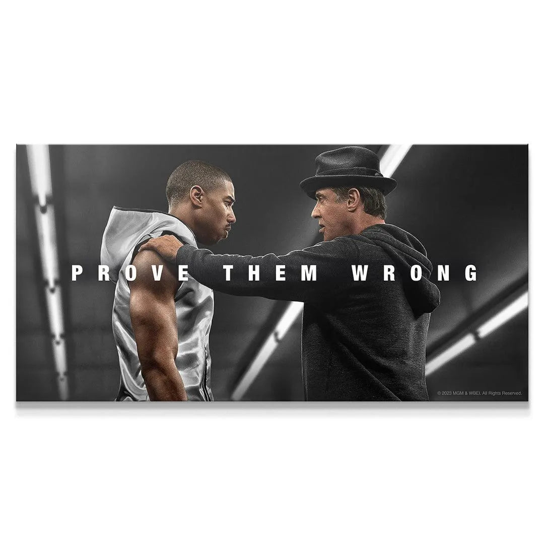 Wide shot of Adonis and Rocky exchanging intense glances in the "Creed - Prove Them Wrong" poster.