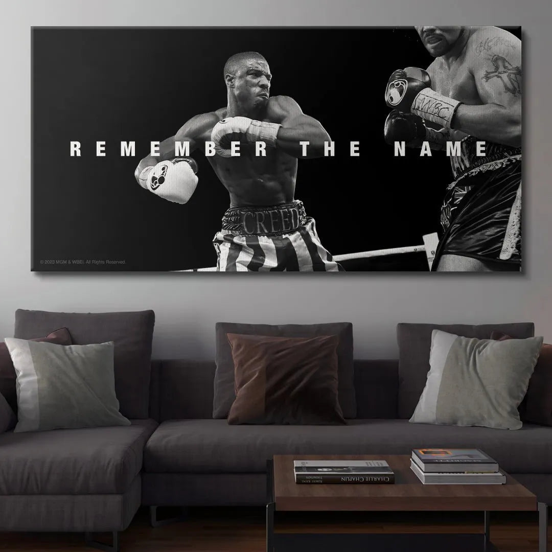 Medium shot focusing on the fighter's posture and striped boxing shorts from the official Creed - Remember The Name memorabilia.