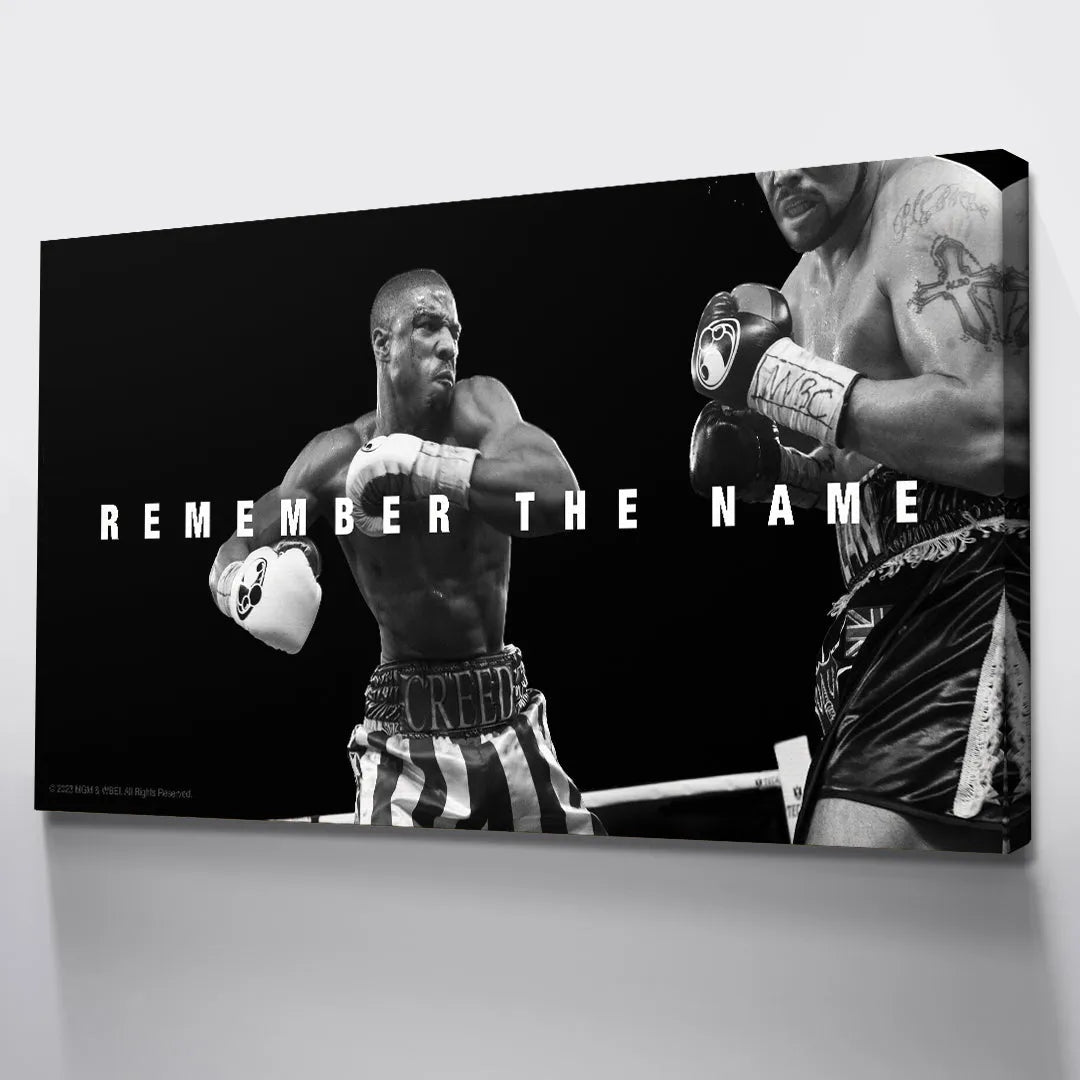 Lifestyle image showing the motivational artwork Creed - Remember The Name hung above gym equipment.
