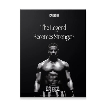 Adonis Creed facing forward in dramatic lighting, showcasing the intensity of Creed - The Legend poster art.