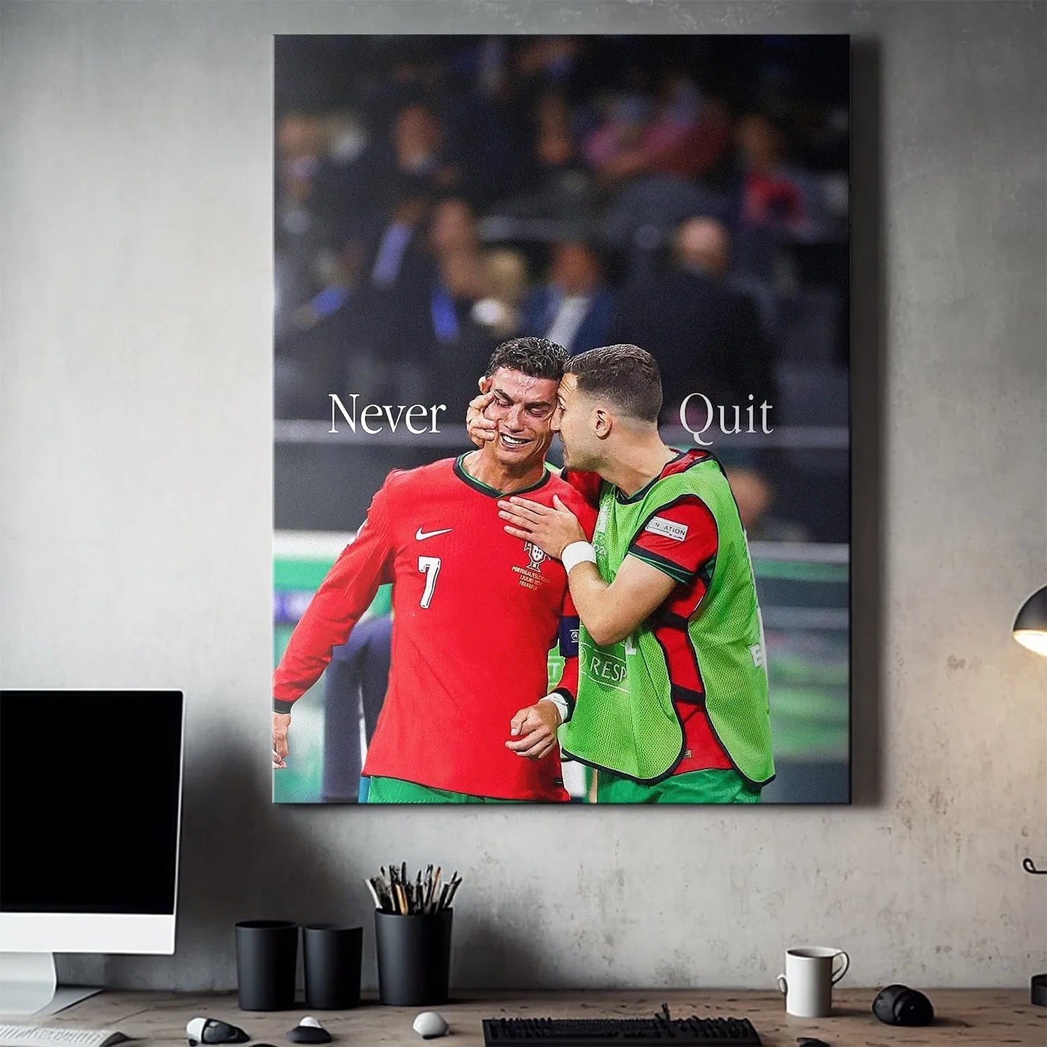 Lifestyle shot displaying the Cristiano Ronaldo - Never Quit poster prominently in a modern office setting.