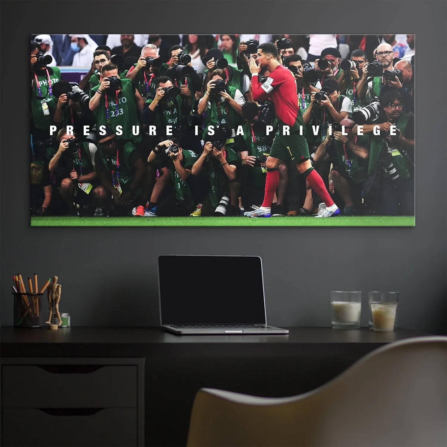 Lifestyle shot of the mounted Cristiano Ronaldo - Pressure Is A Privilege print hanging in a modern, inspirational office setting.
