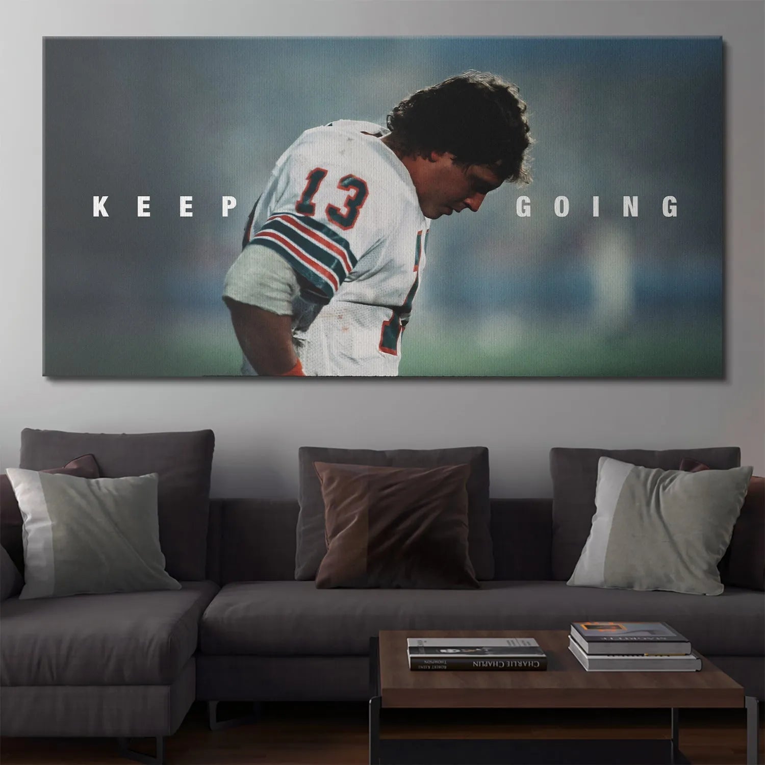 Lifestyle image of the quarterback art print 'Dan Marino - Keep Going' displayed above a home office desk.