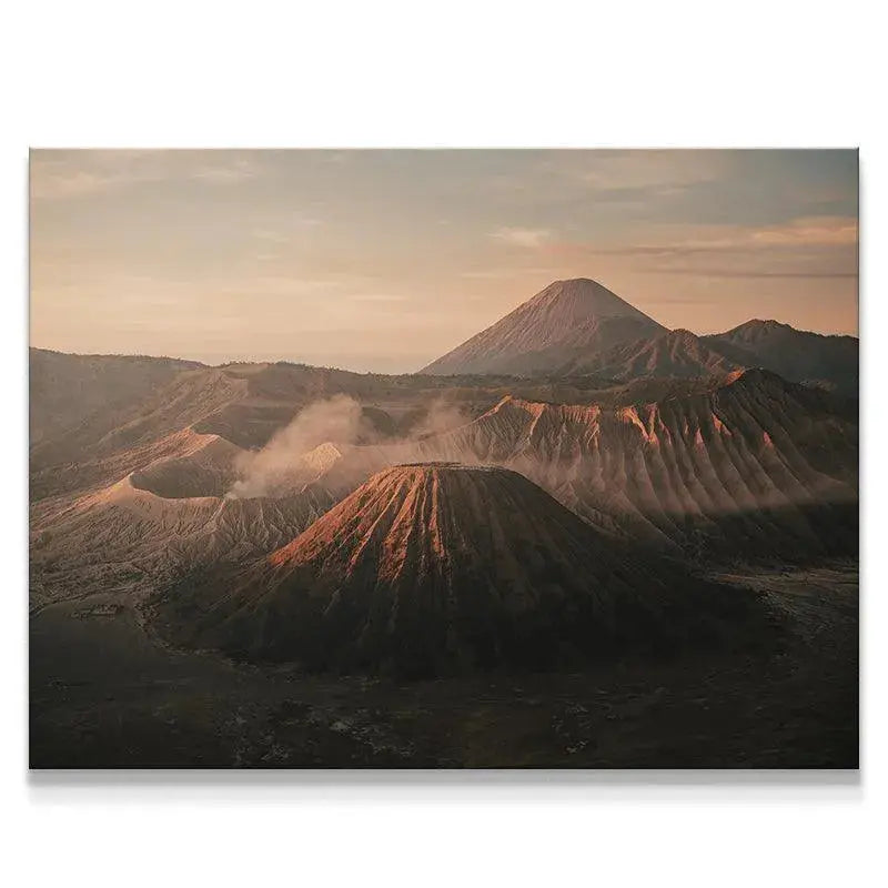 Wide view of the Tengger caldera at Dawn of Bromo, showing multiple volcanic peaks and steam plumes.