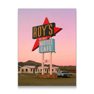 Full wide shot of Roy's Motel Cafe sign and vintage car under a pink sunset, epitomizing the 'Desert Dreams' aesthetic.