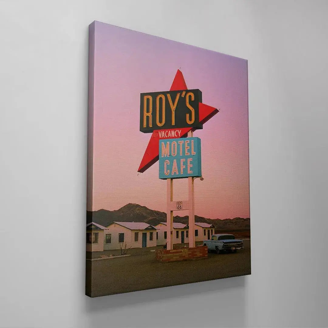 Ground level view showing the dusty foreground and white motel buildings of Roy's in the 'Desert Dreams' photo print.