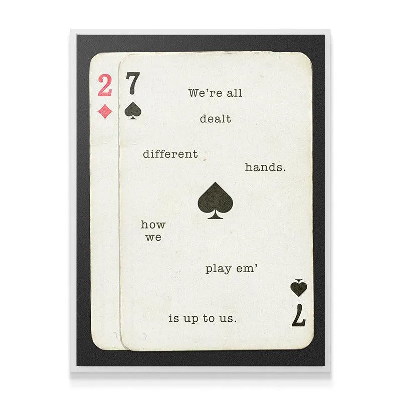 Angled shot highlighting the black typography and spade symbol on the 'Different Hands' design.