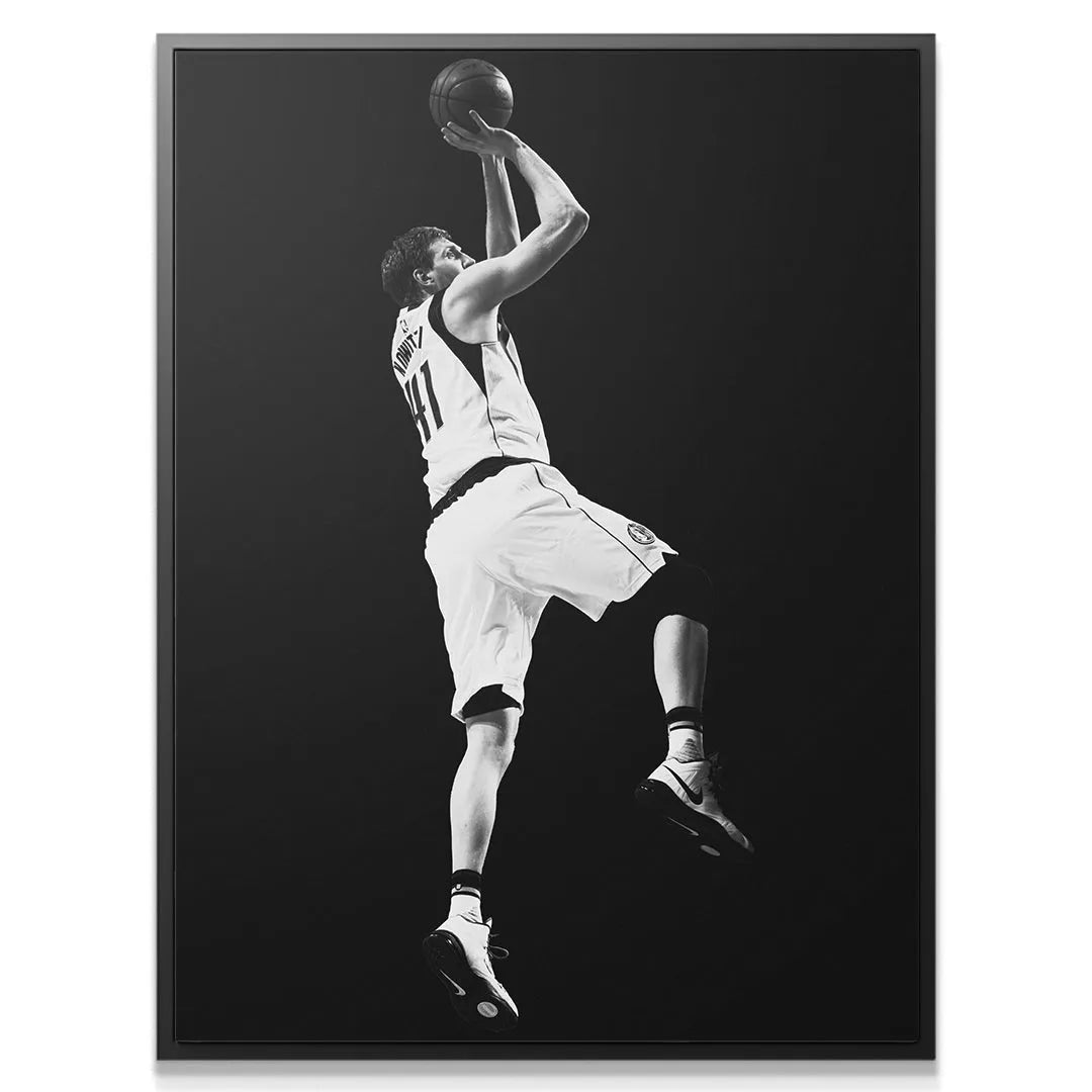 Close-up texture view of the basketball held overhead by Dirk Nowitzki - #4 during his jump.