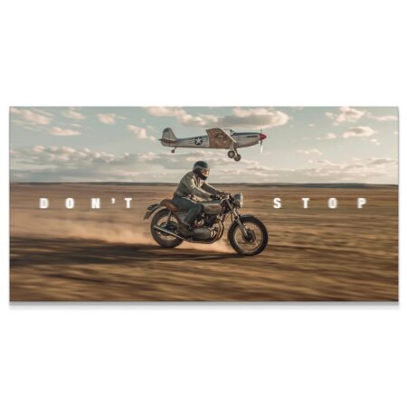 Wide shot of a motorcyclist and vintage airplane flying low over a dusty landscape, embodying 'Don't Stop Racing'.