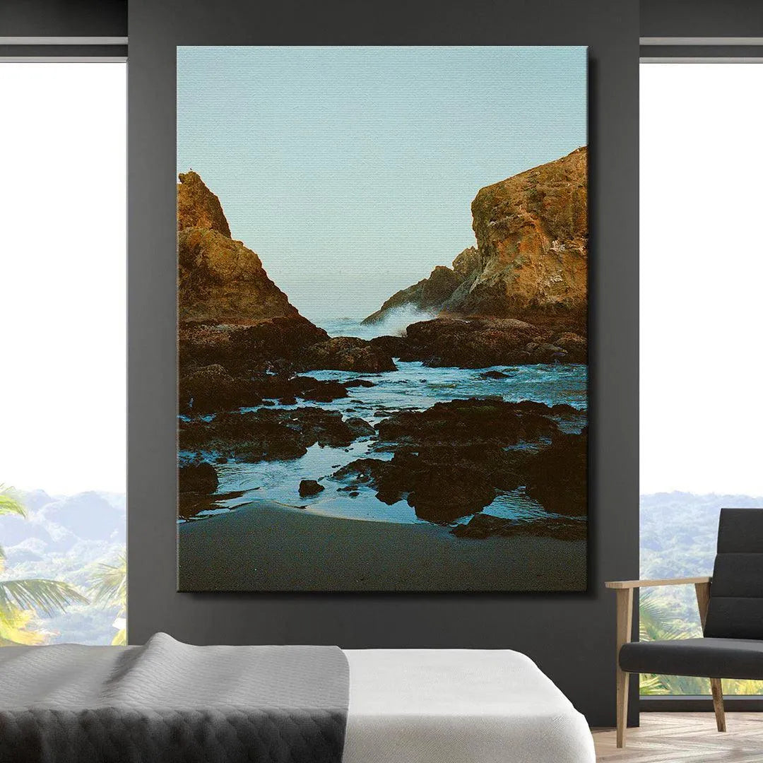 Mid-frame perspective emphasizing the churning blue water hitting the moss-covered rocks within Dreaming In Bandon.