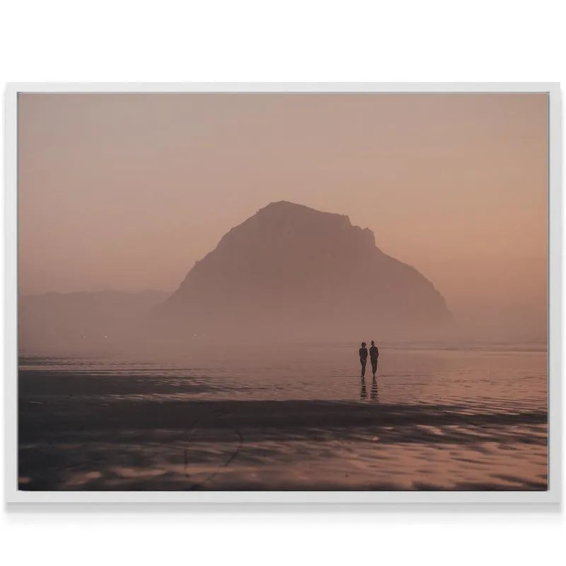 Wide-angle perspective of the large coastal mountain dissolving into the pink and orange sky of 'Dusk Walks'.