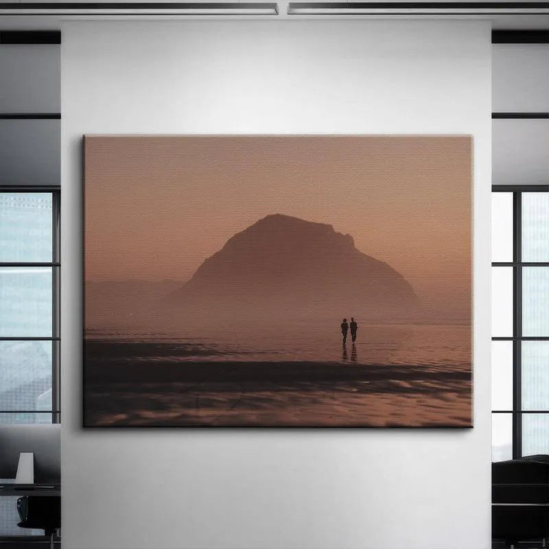 Lifestyle shot showing the framed 'Dusk Walks' print mounted above a minimalist bedroom headboard.