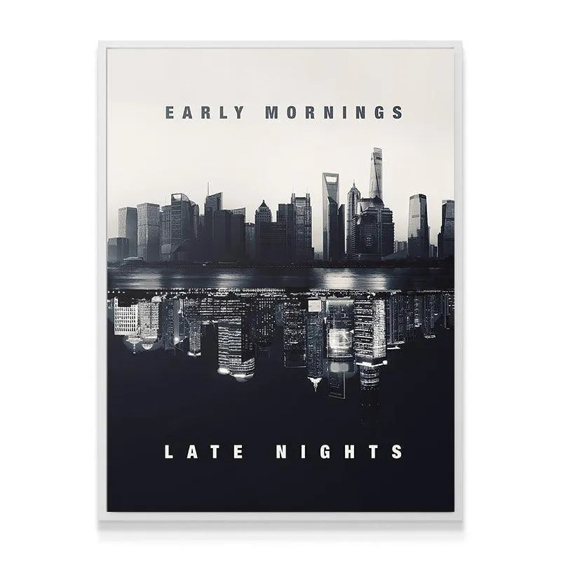 Wide shot showing 'Early Mornings. Late Nights. (B&W)' artwork mounted above a contemporary, minimalist office desk setup.