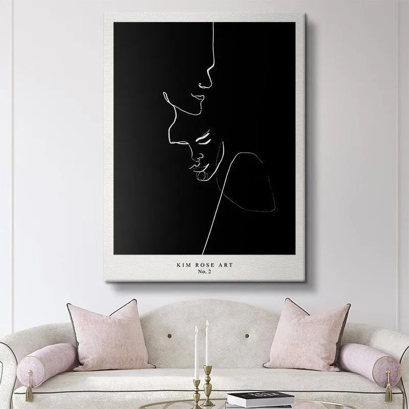 Lifestyle staging of 'Embrace - Black' framed on a white gallery wall in a modern apartment.