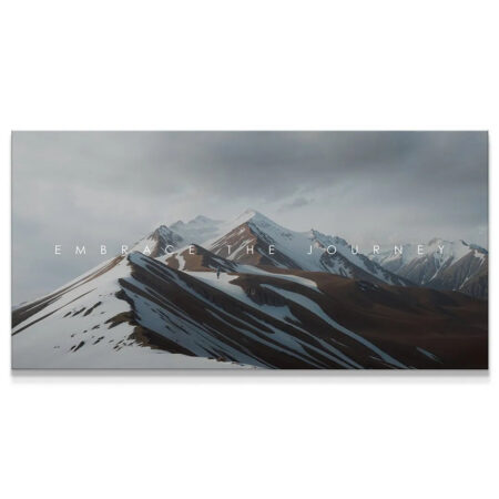 Wide shot of snow-dusted, rugged mountains emphasizing the motivational text 'Embrace The Journey'.