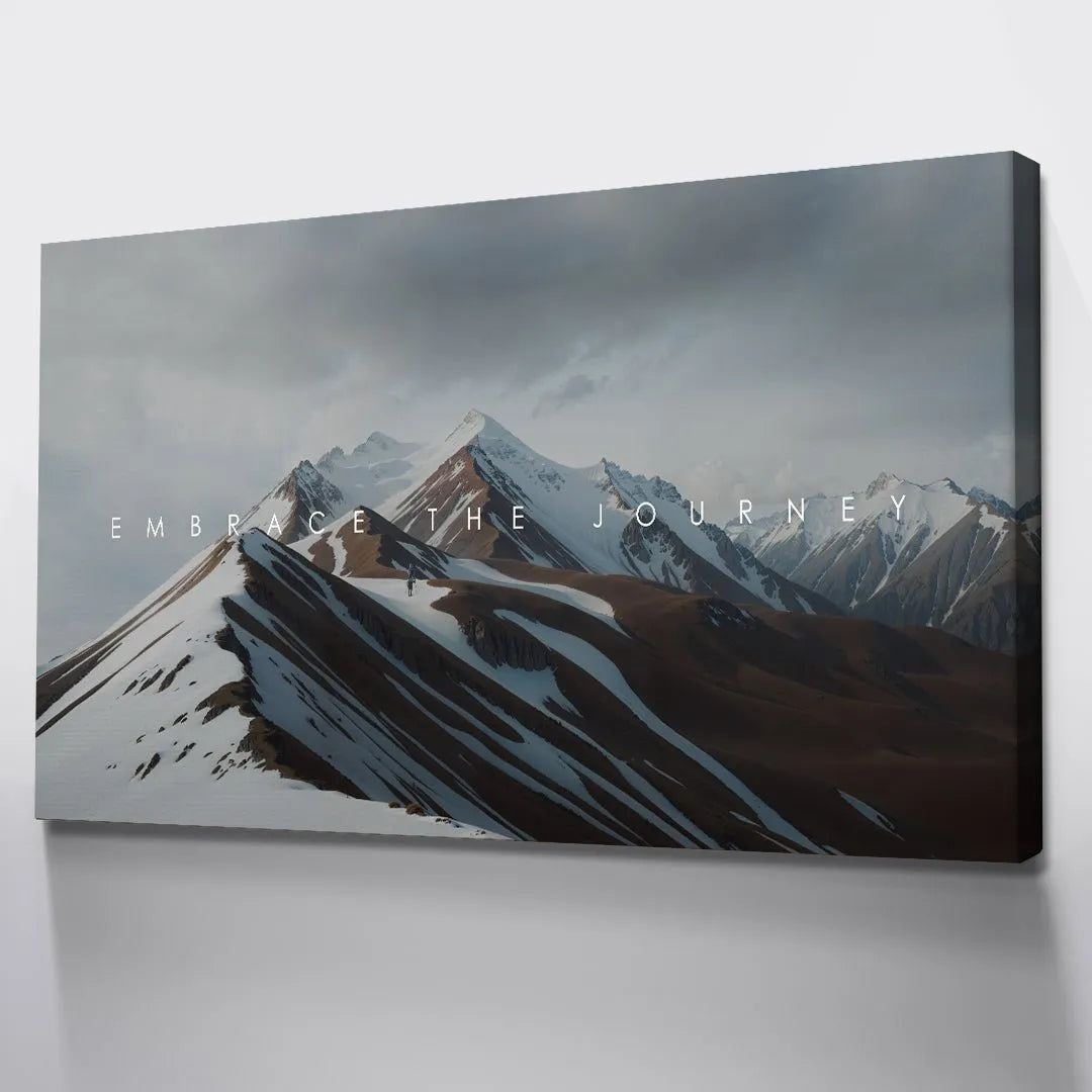 Detail shot focusing on the crisp white typography and how it overlays the mountain terrain to define 'Embrace The Journey'.