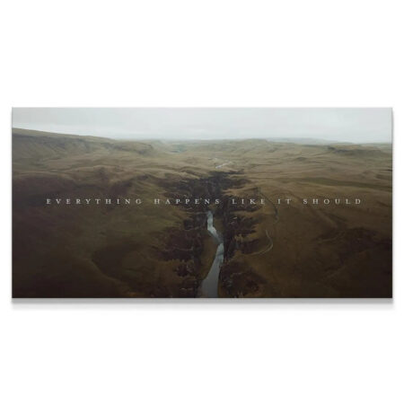 Aerial view of a dramatic canyon landscape canvas affirming "Everything Happens Like It Should."