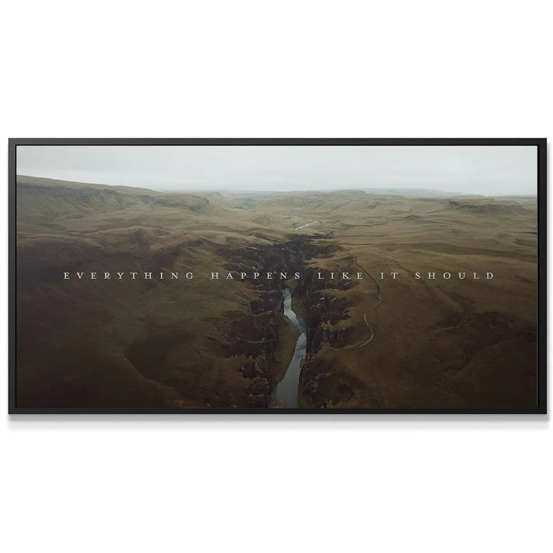 Close-up shot of the white textual overlay "Everything Happens Like It Should" against the dark river gorge.