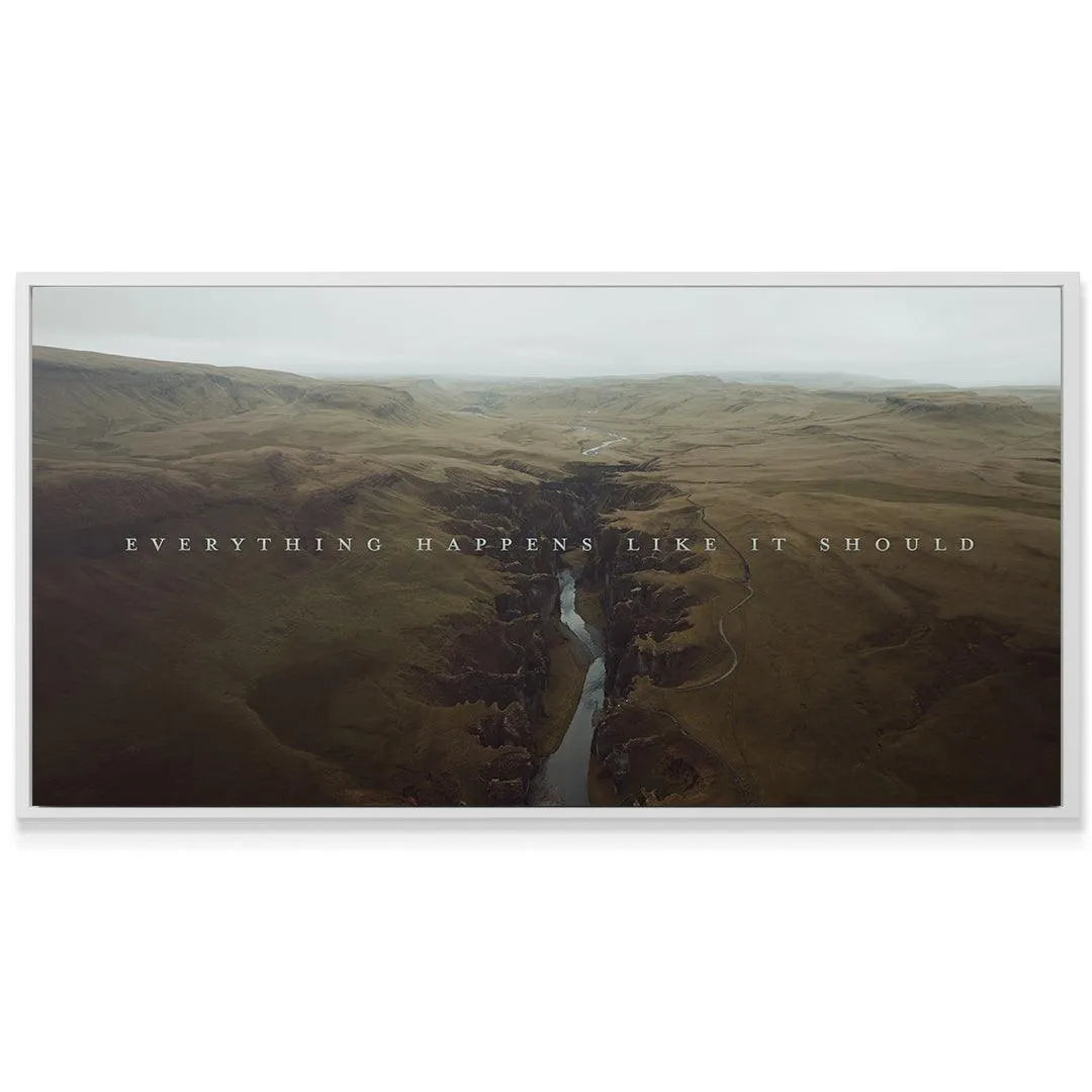 Panoramic print displayed in a modern living room setting confirming "Everything Happens Like It Should."