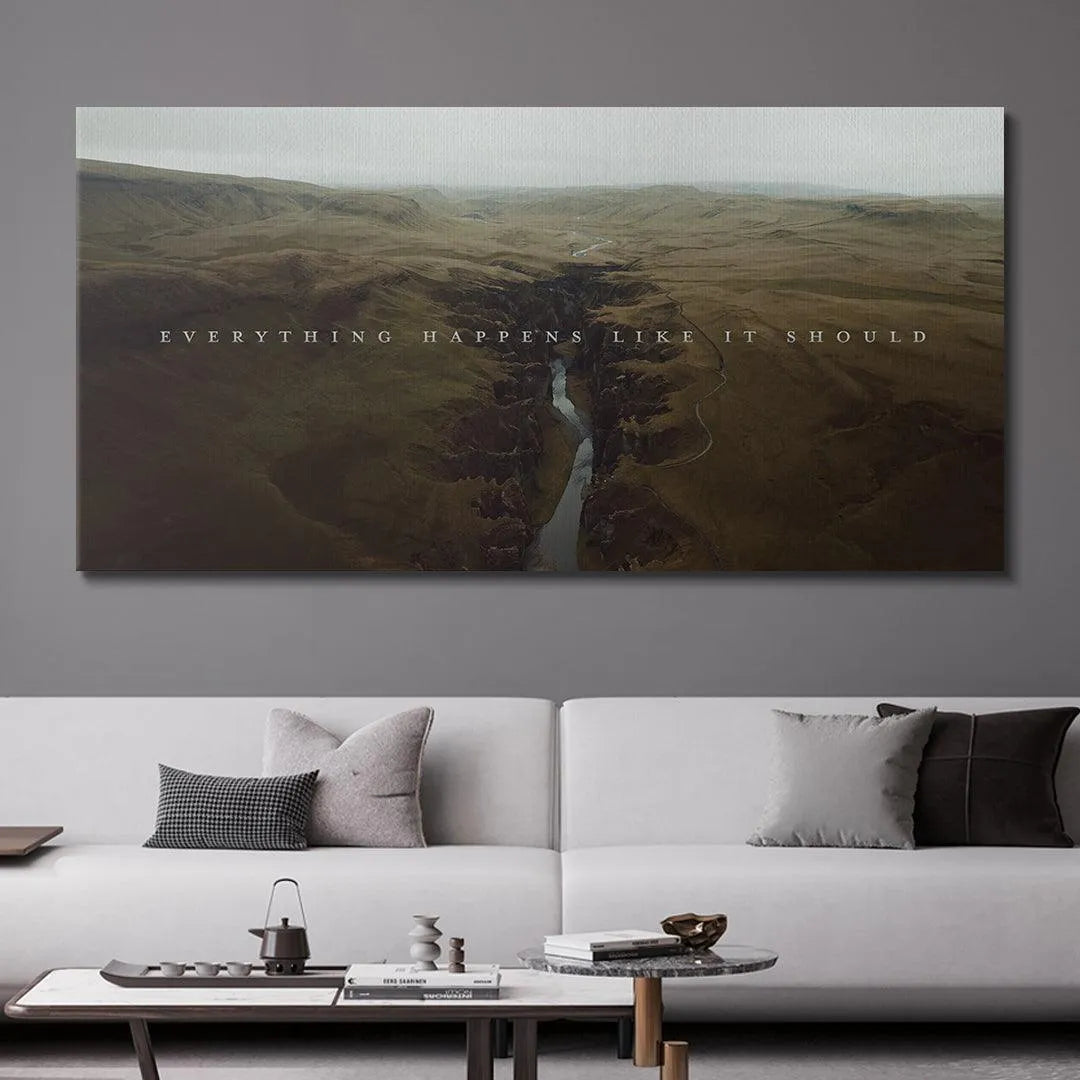 Horizontal view of the vast, rugged terrain where "Everything Happens Like It Should" is superimposed.