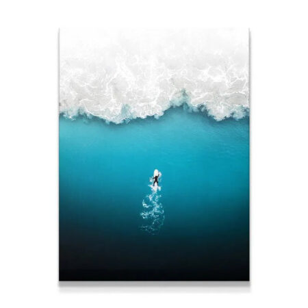 Aerial view of a lone surfer paddling towards a crashing wave, symbolizing the courage required to Face Your Fears.