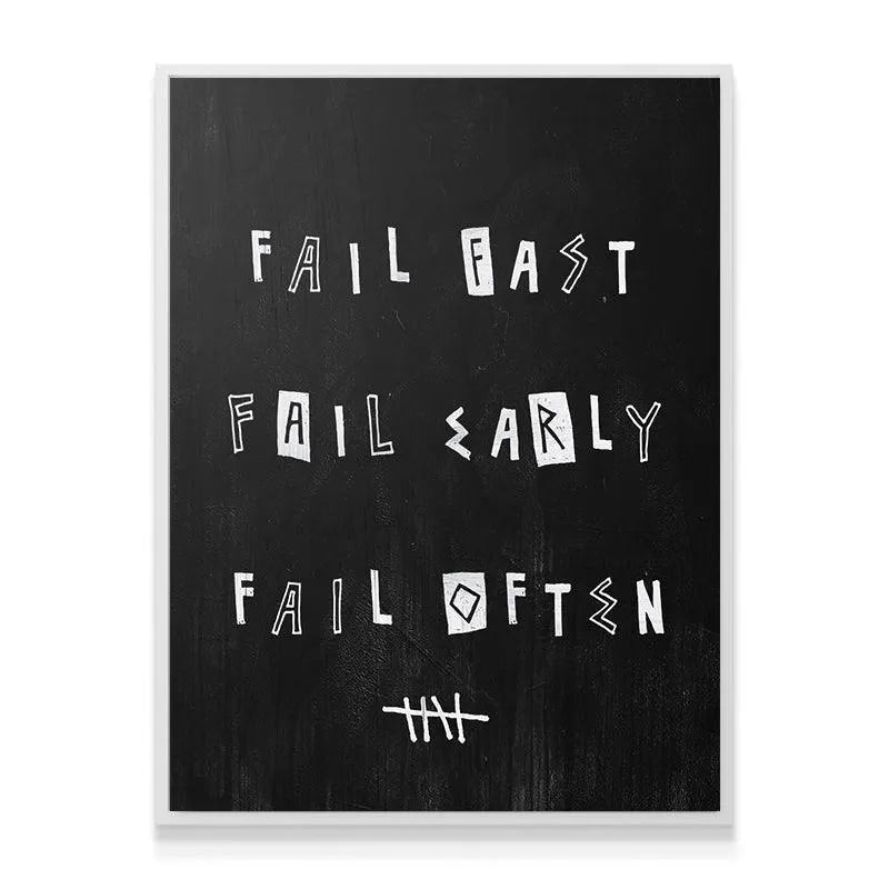 Lifestyle mock-up of the 'Fail Fast. Fail Early. Fail Often.' print hanging above a modern office desk.