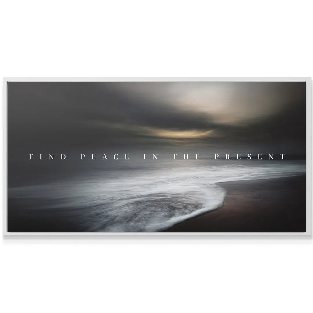 Detail of the foamy white wave motion on the dark sand conveying the message 'Find Peace In The Present'.