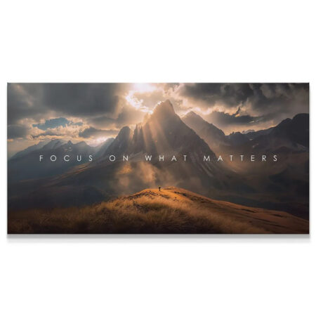 Panoramic view of mountains at sunset with text "Focus On What Matters"