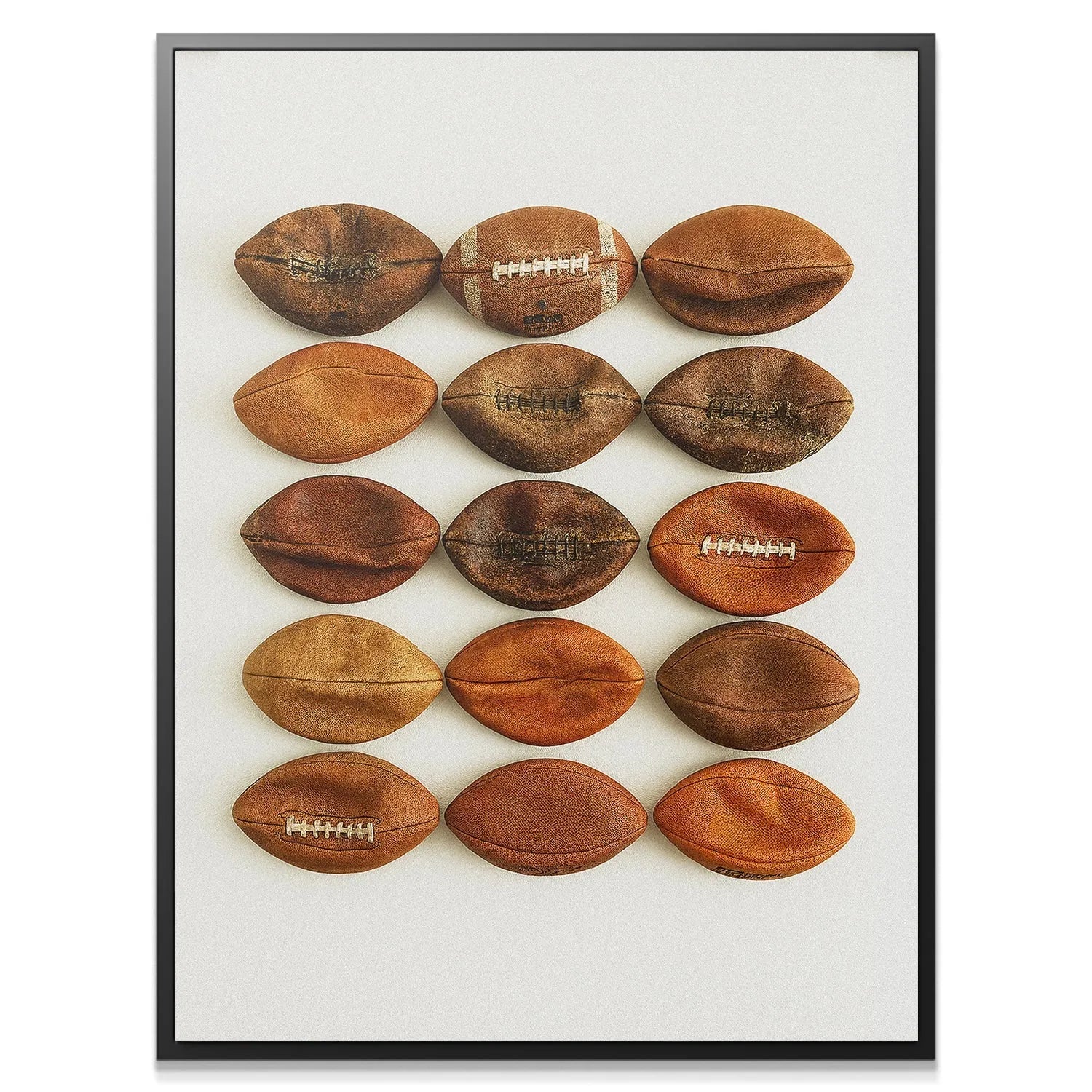 Full overhead view of the 15 deflated balls forming the Football Wall grid artwork.