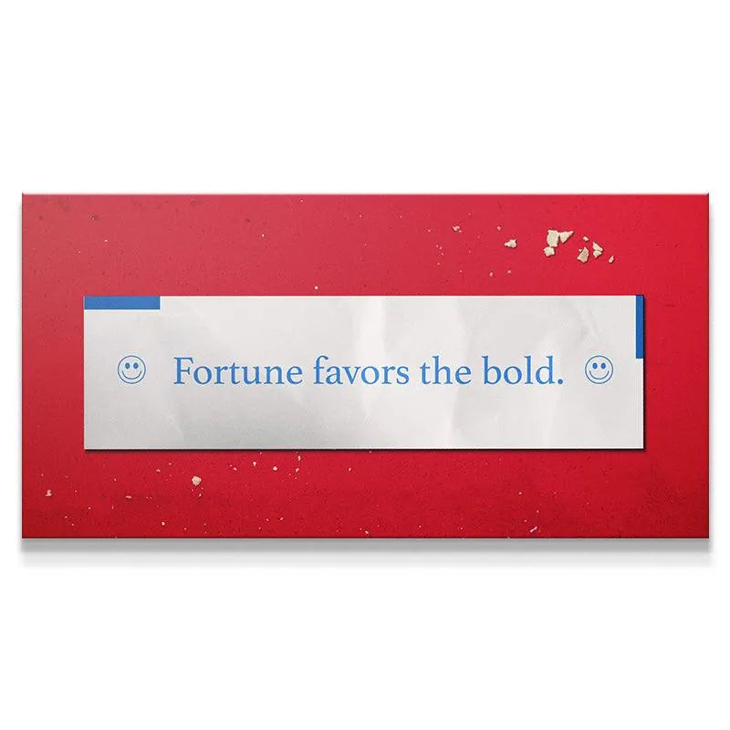 Extreme close-up of the blue text on the white slip reading "Fortune Favors The Bold" with small smiley face icons.