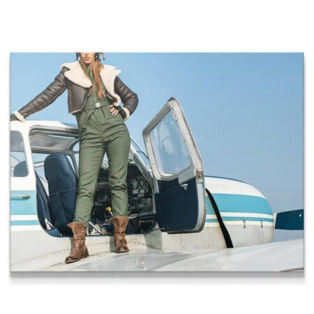 Full shot of vintage female pilot standing on the airplane wing, titled Friendly Skies.
