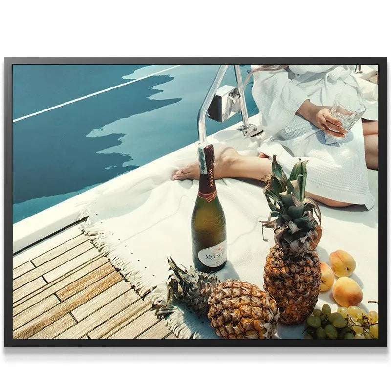 Lifestyle shot of a relaxed person holding a drink, enjoying Fruits and Champagne on the yacht deck.