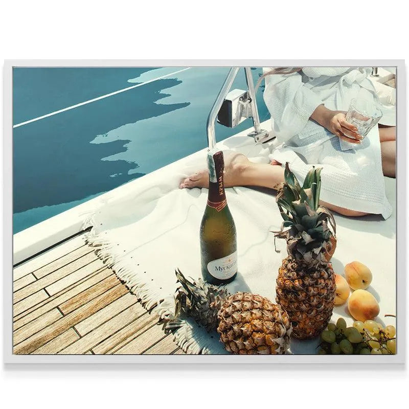 Wide angle view showing the teak deck, blue water, and the lavish spread of Fruits and Champagne.