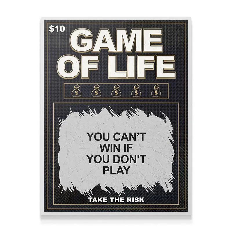 Lifestyle image showing the 'Game of Life' canvas art hanging above a modern office desk setup.