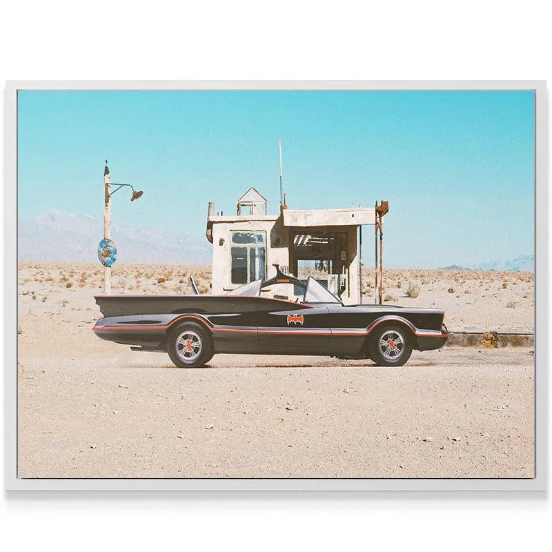 Wide-angle view showcasing the vast, sandy desert landscape surrounding the structure at the 'Gas Stop'.