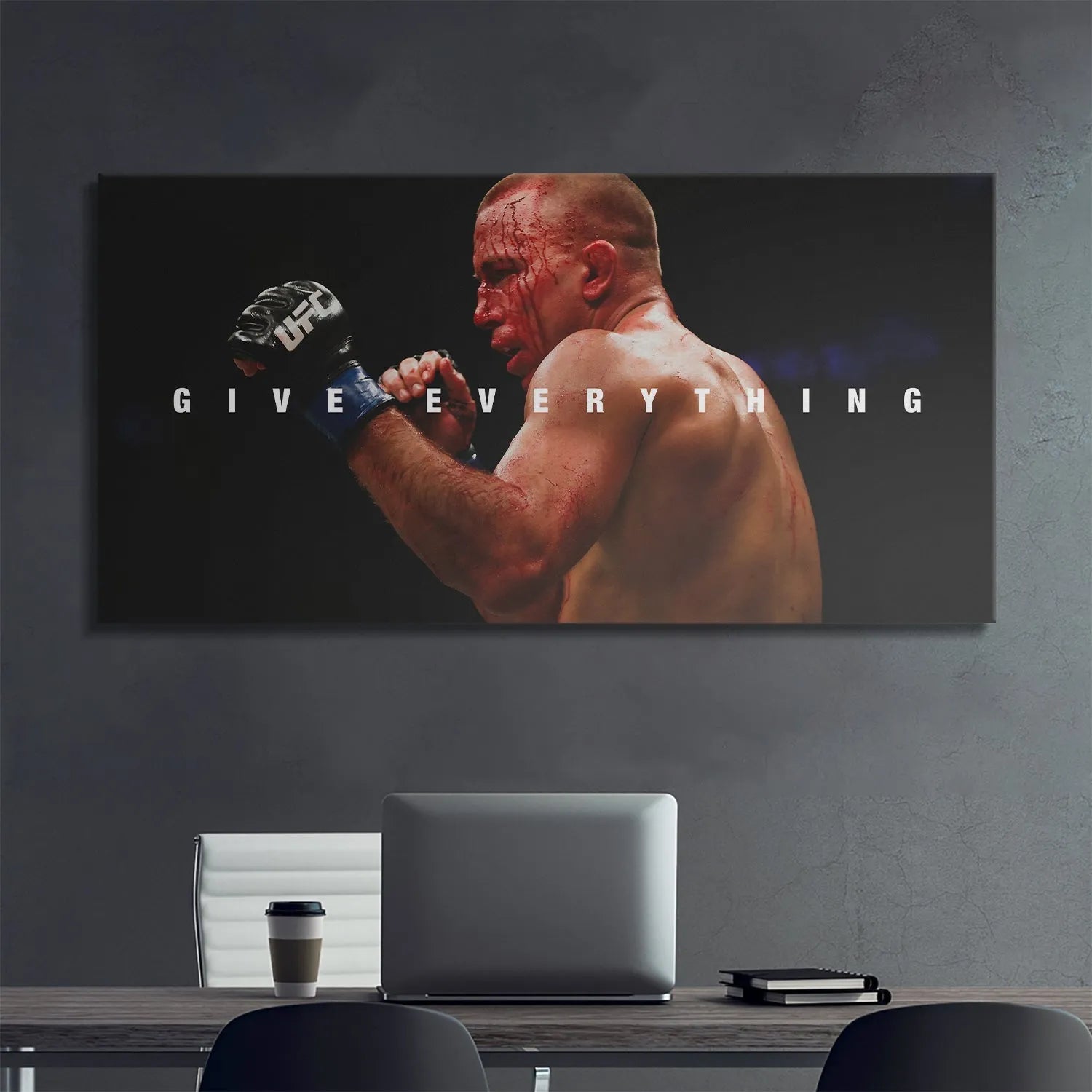 High-angle perspective showing the fighter's defined shoulders and back musculature: George St. Pierre - Give Everything