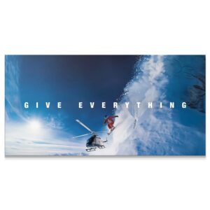 Give Everything – Jump Wall Art Wide-angle view of skier initiating a massive 'Give Everything - Jump' off a snowy cliff edge.