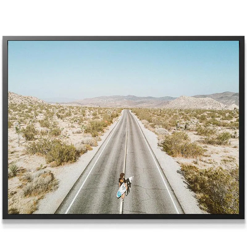 Close-up detail of the long, straight asphalt road cutting through the arid landscape in the Going Places photo.