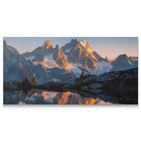 Wide panoramic view of the 'Golden Ridge' mountain range at sunset reflected in water.